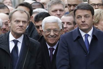 Mahmoud Abbas smirking while at remembrance rally for Charlie Hebdo in Paris after terror slaughter of a dozen writers and cartoonists for the satirical magazine.