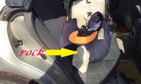 Rock Almost Striking Child Landing in Child Seat after crashing through Side Window and Barely Missing Mother in Front Seat