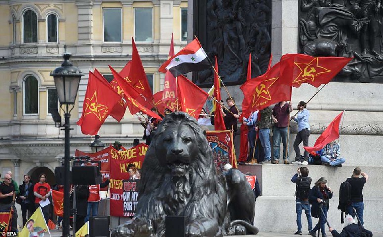 Marchers at May Day, International Workers' Day Rally Waving the Red Flag Banners